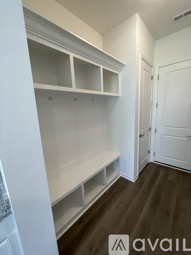 A white closet with shelves and a door.
