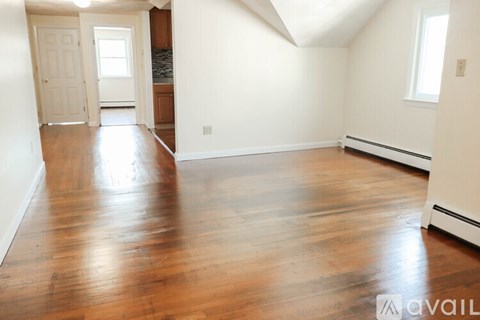 A black and white image of a house floor plan with a living room, dining room, kitchen, and four bedrooms.