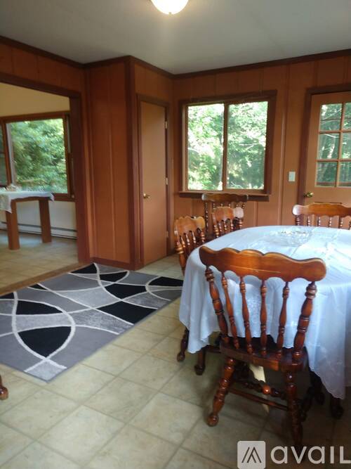 A dining room with a table set for four.