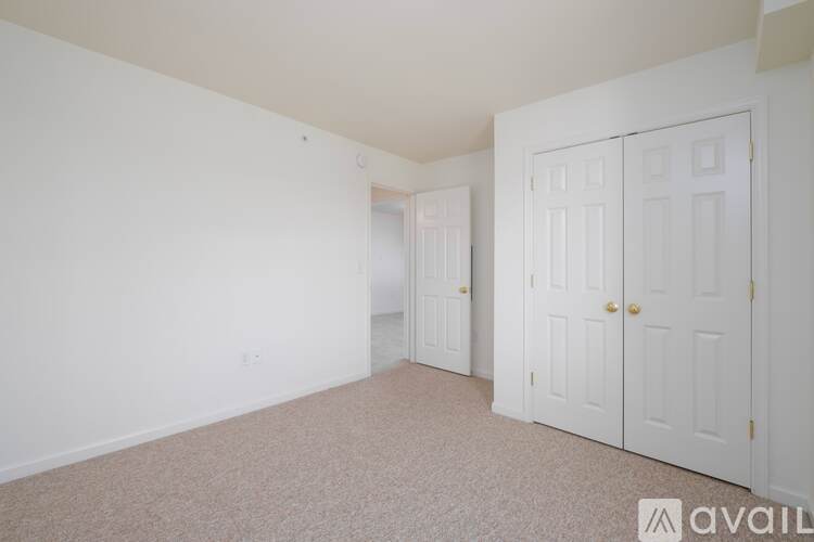 A room with a window and a door is available for rent.