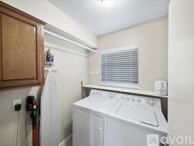 A small laundry room with a washer and dryer.