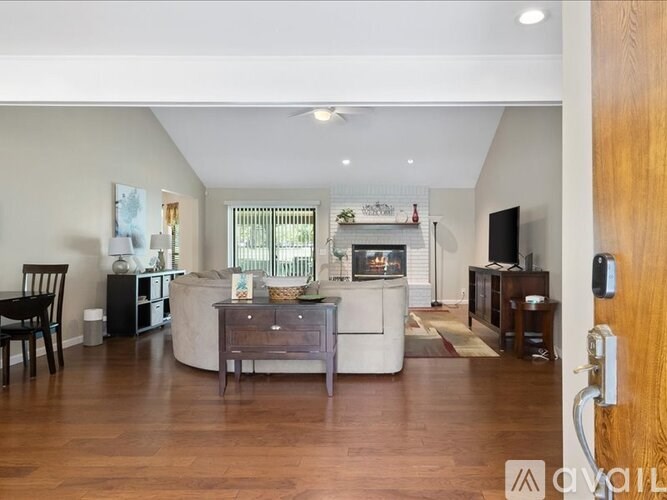 A modern living room with a fireplace and a television.