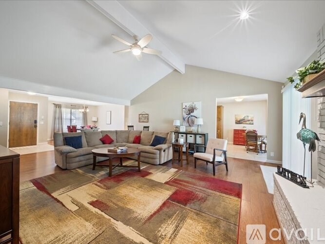 A living room with a rug and a couch.