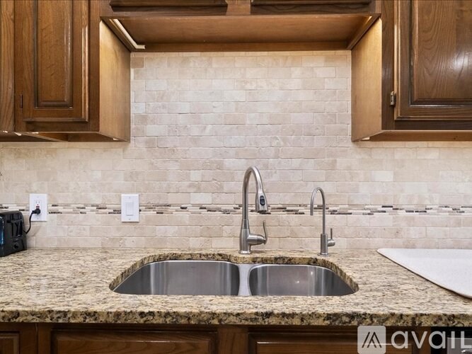A kitchen with a granite countertop and a sink.