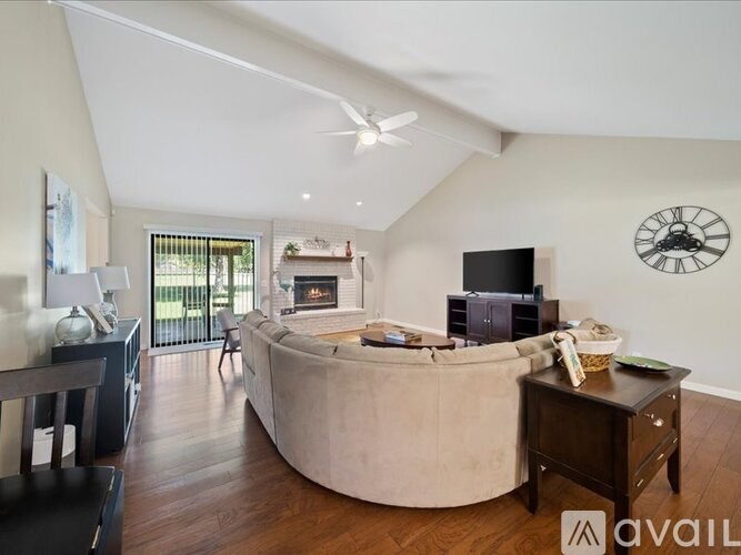 A living room with a large couch and a flat screen TV.