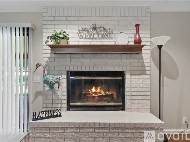 A fireplace with a sign that says "Happiness" on the mantle.