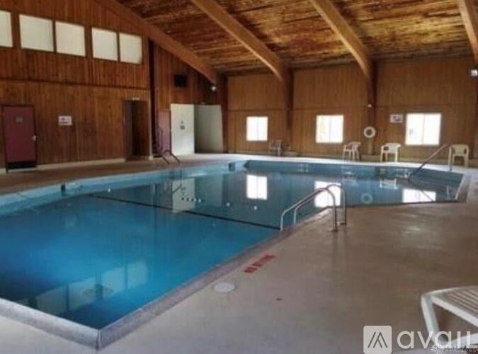 A large indoor swimming pool in a wooden building.
