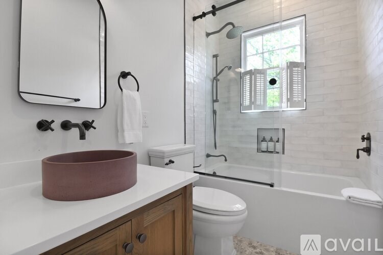 A bathroom with a white countertop and a brown bowl on it.