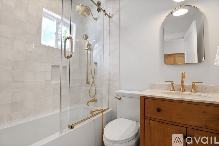 A bathroom with a toilet, sink, and shower.