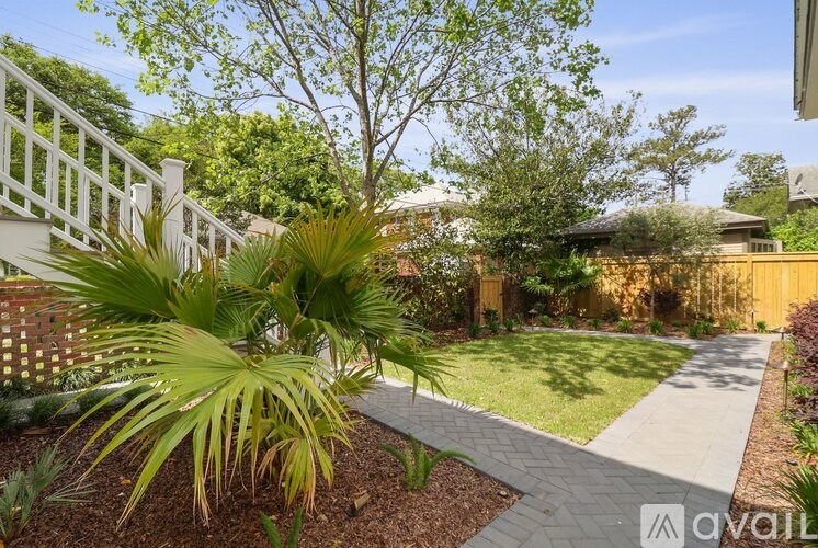 A garden with a white fence and a pathway.