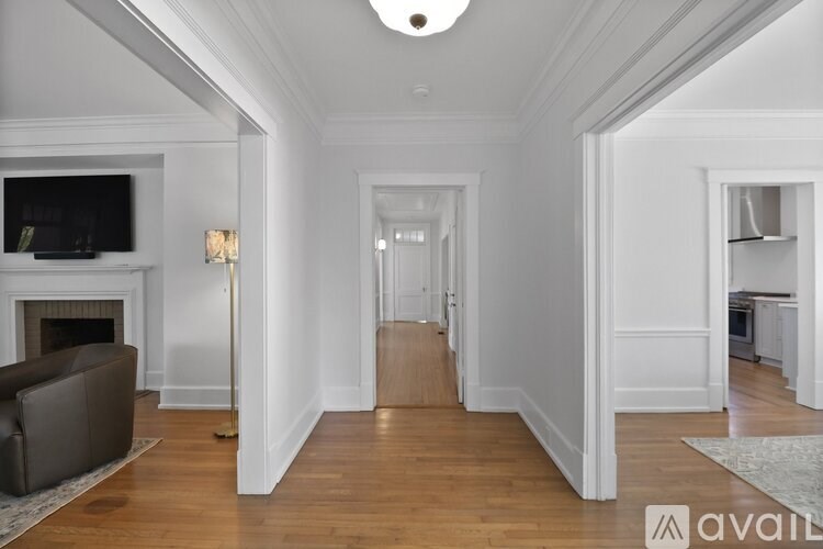 A living room with a fireplace and a television.