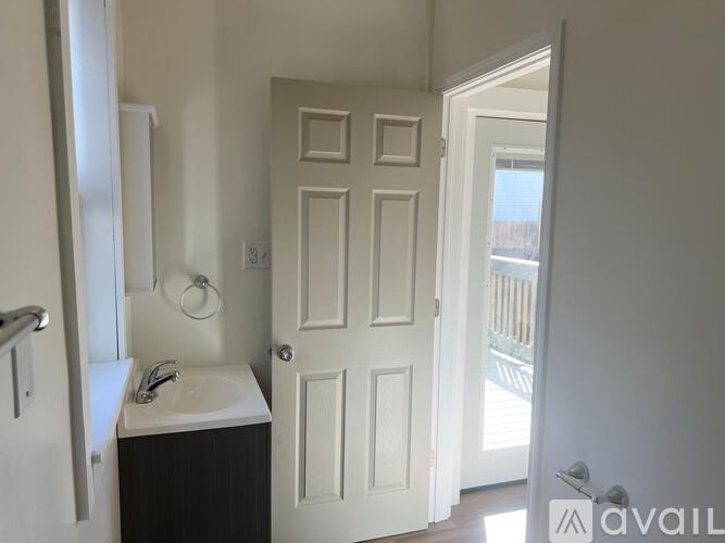 A bathroom with a sink and a door.