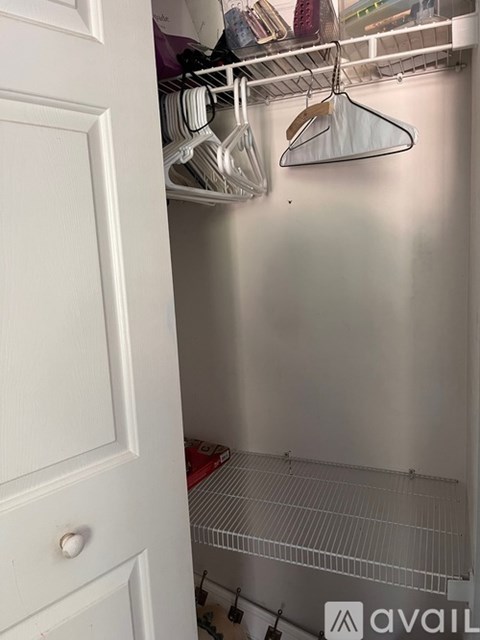 A white door is open to a small, empty kitchen.