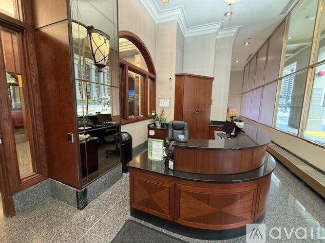 A reception area with a wooden desk and a glass door.