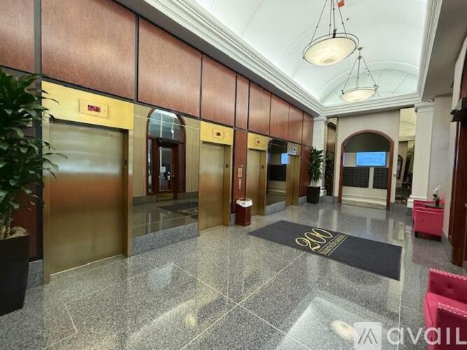 A hallway with a marble floor and a ceiling light.