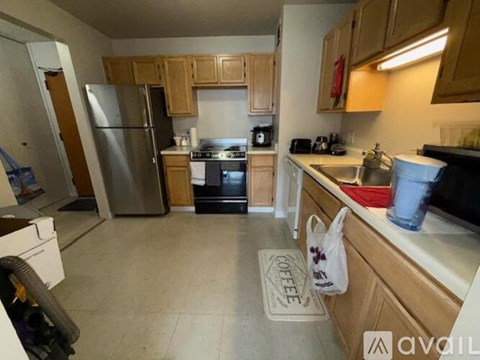 A kitchen with wooden cabinets and a black stove top oven.