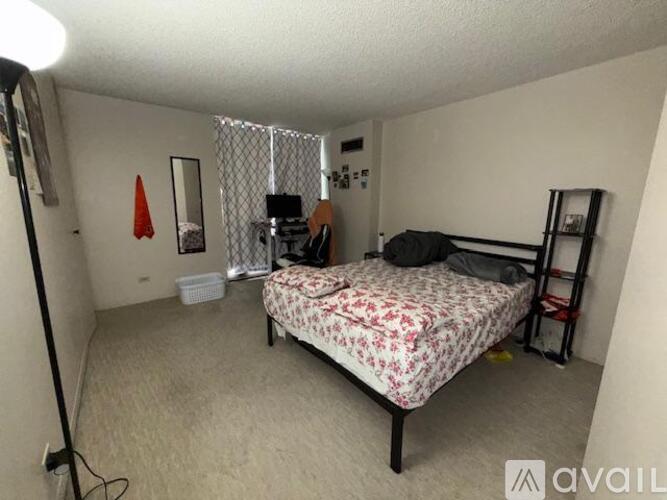 A bedroom with a bed, a chair, and a desk.