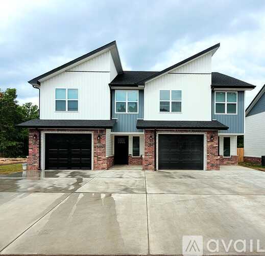 A two-story house with a garage on the ground floor.