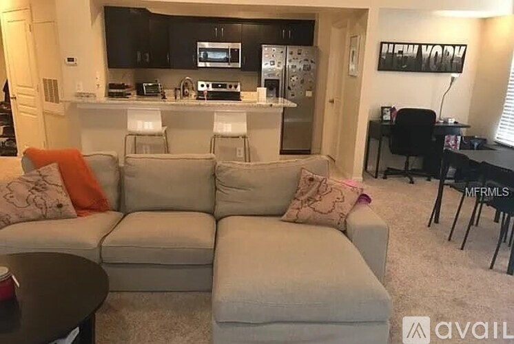 A kitchen with a stove top oven and microwave built into the cabinetry.
