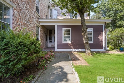 A house with a red brick exterior and a white door.