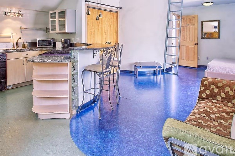 A kitchen with a dining table and chairs.