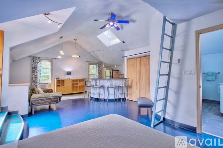 A room with a blue floor and a ceiling fan.