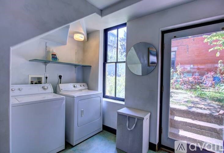 A small bathroom with a washer and dryer.