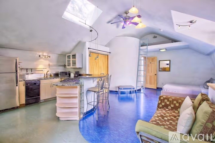 A kitchen with a dining table and chairs in the middle of the room.
