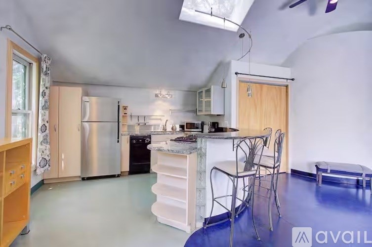 A kitchen with a blue floor and white walls.