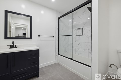 A kitchen with a white counter top and a white fridge with a black handle.