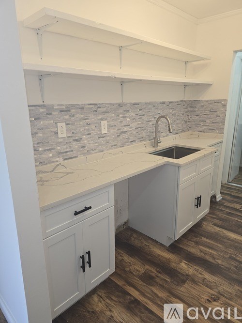 A kitchen with a sink and cabinets.