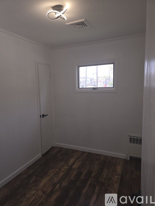 A room with wooden floors and a window.