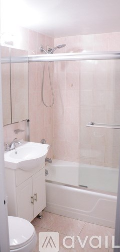 A bathroom with pink walls and a white sink.