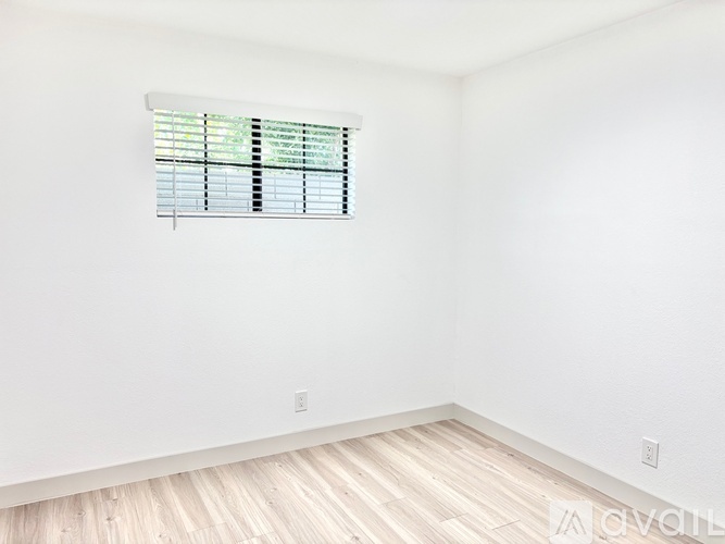A room with a window covered in blinds.