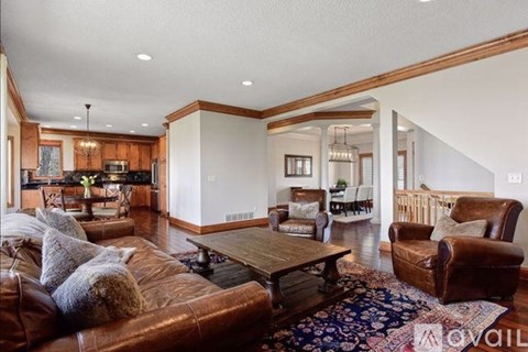 A living room with a brown leather couch and a wooden coffee table.