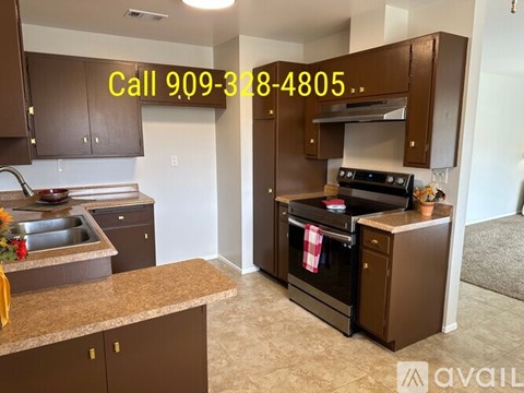 A kitchen with brown cabinets and a countertop is available for rent.