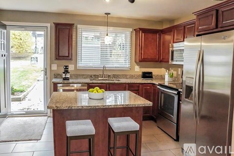 A kitchen with wooden cabinets and stainless steel appliances.