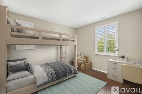 A bedroom with a bunk bed, desk, and chair.