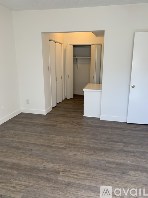 A room with a white door and a white cabinet.