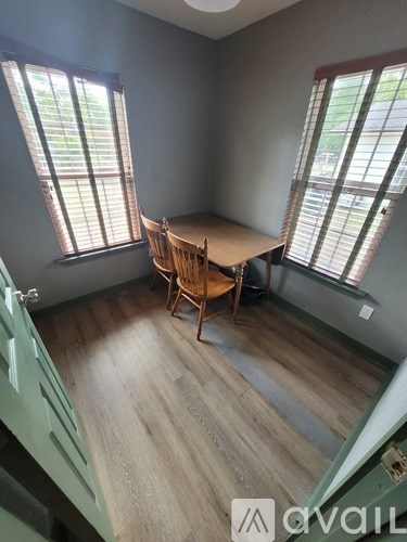 A room with a wooden table and chairs.