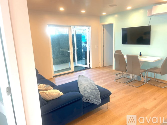 A living room with a blue couch and a television.