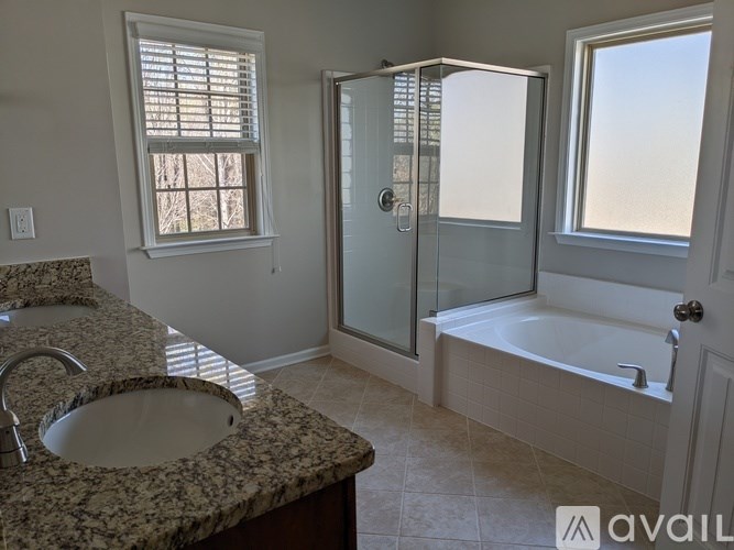 A bathroom with a sink, tub, and shower.