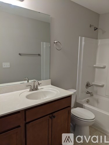 A bathroom with a sink, toilet, and bathtub.
