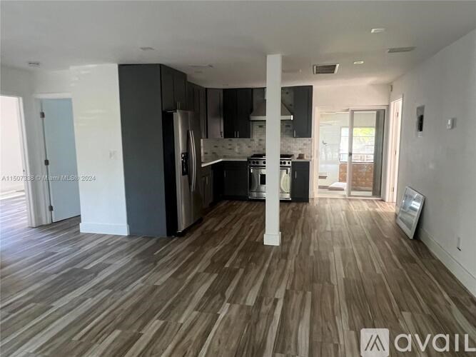 A kitchen with a refrigerator, oven, and sink is available for rent.