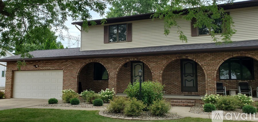 A house with a garage and a brick wall.