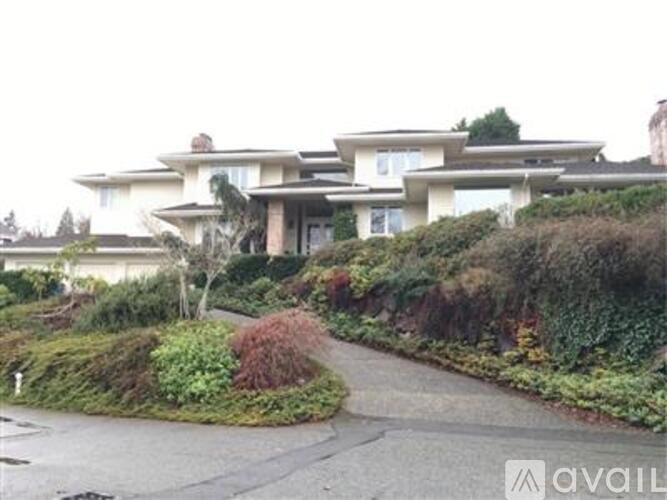 A large house with a driveway in front of it.