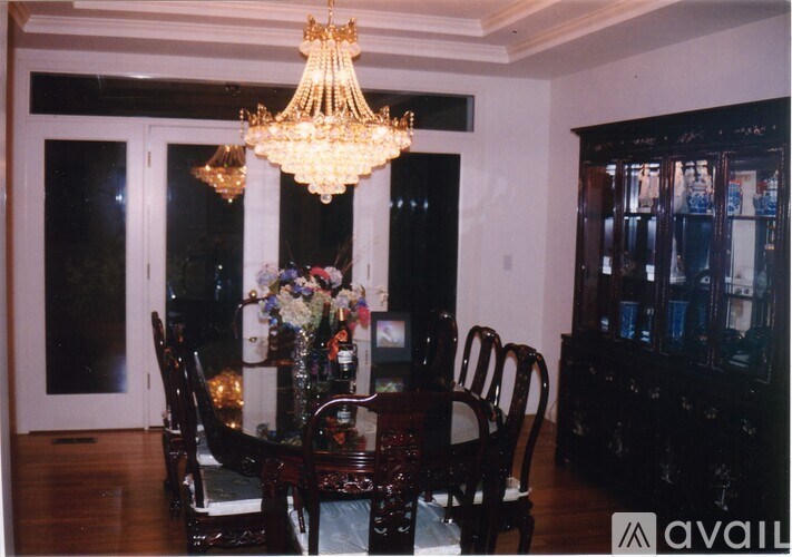 A dining room with a table set for six.