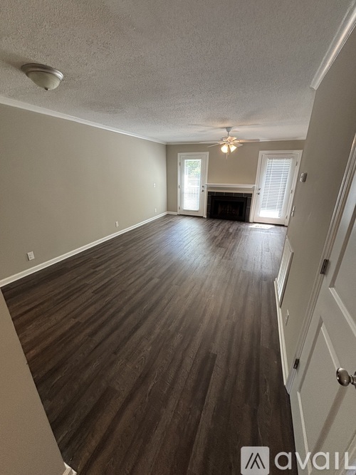 A room with wooden flooring and a ceiling fan.
