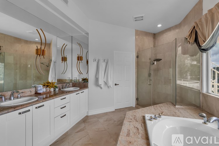 A bathroom with a tub, sink, and shower.