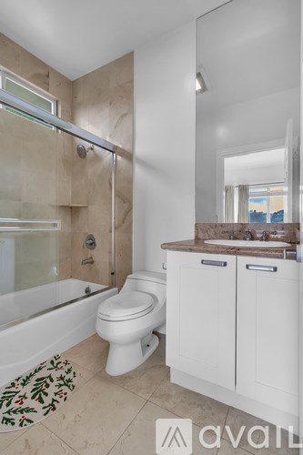 A bathroom with a toilet, sink, and bathtub.